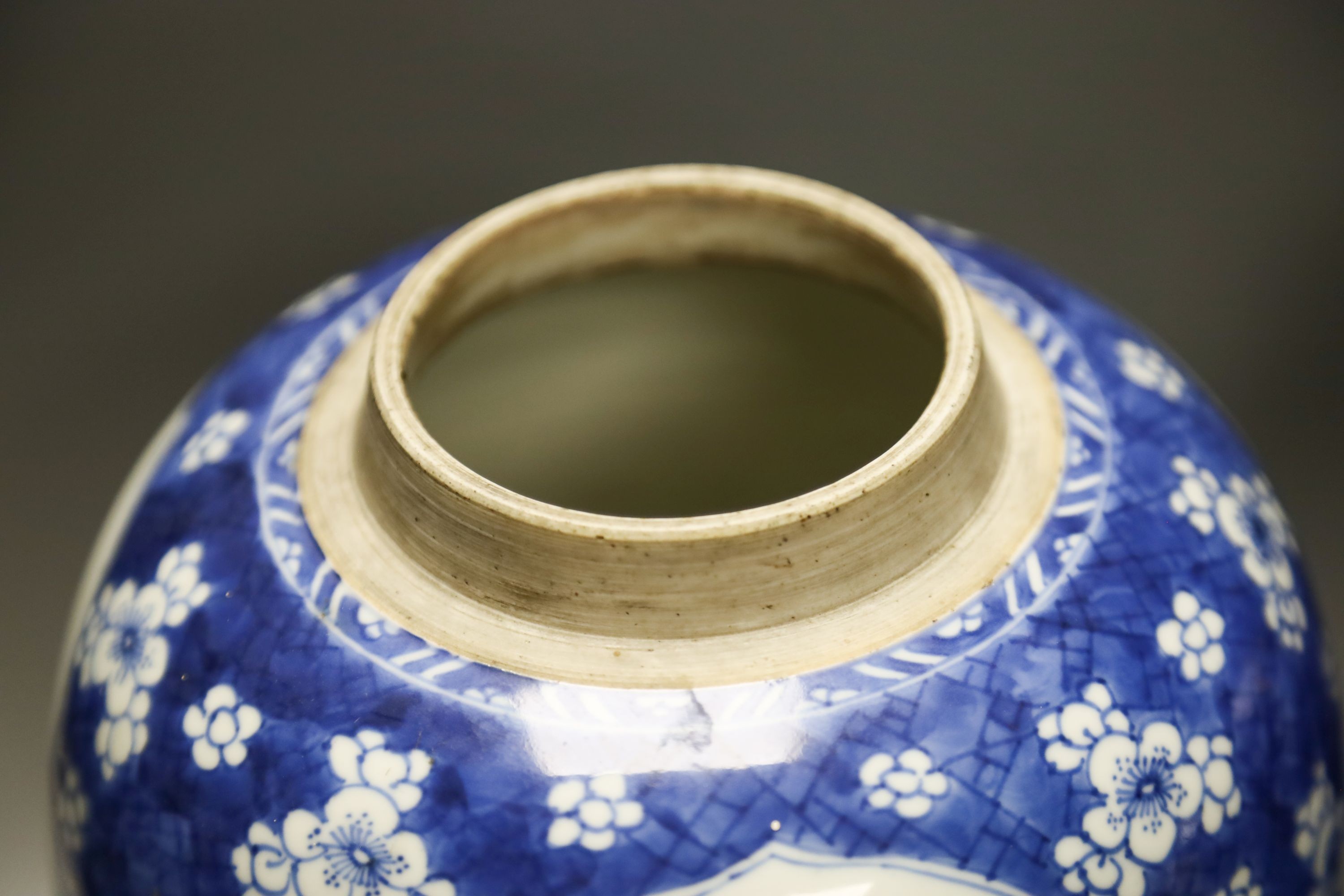 A Chinese Kangxi blue and white hundred antiques jar, 21cm, cracked, with hardwood stand and a Samson powder blue jar, 26cm, wear